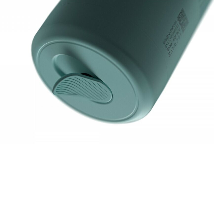 Teal-colored electronic sexual wellness device for men on a white background