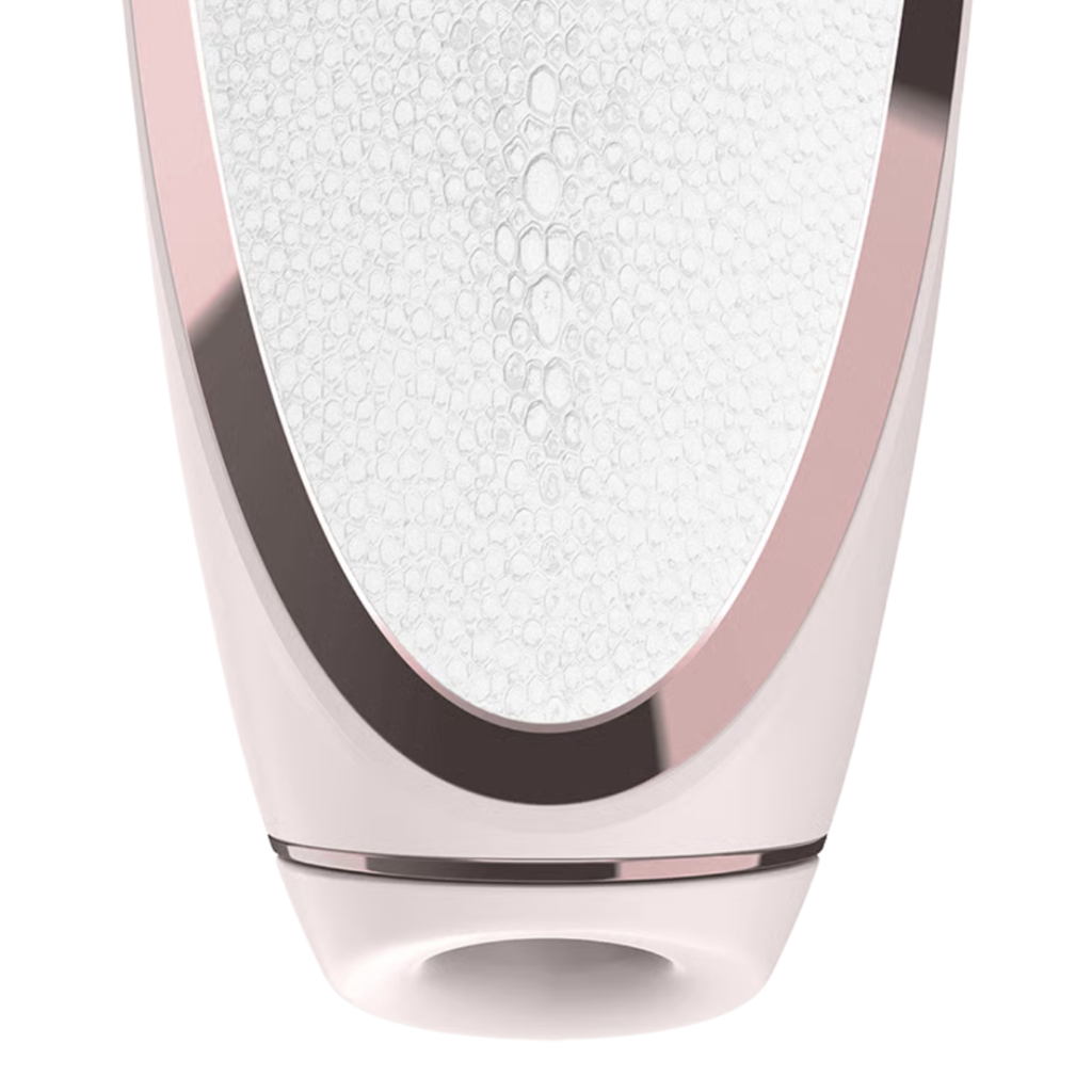 Close-up of a luxury skincare device with a white surface and rose gold accents.