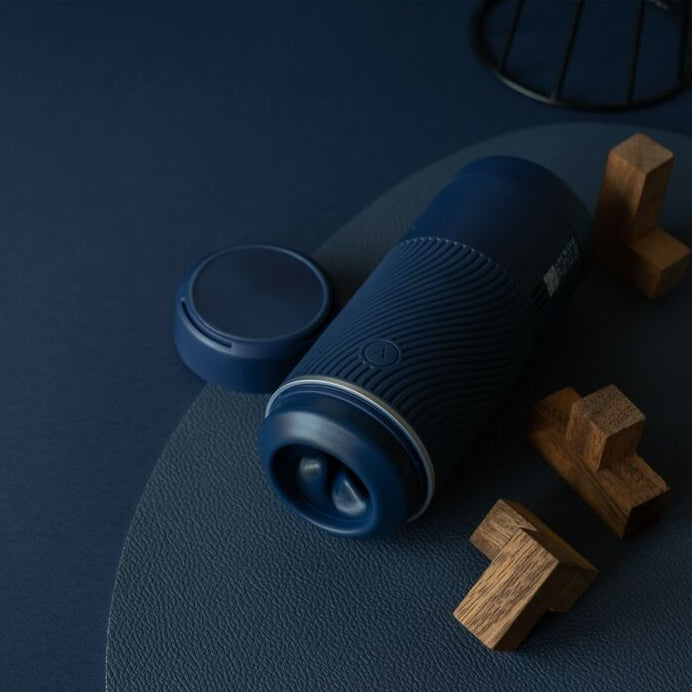 Blue cylindrical masturbator for men with wooden blocks on a dark blue background