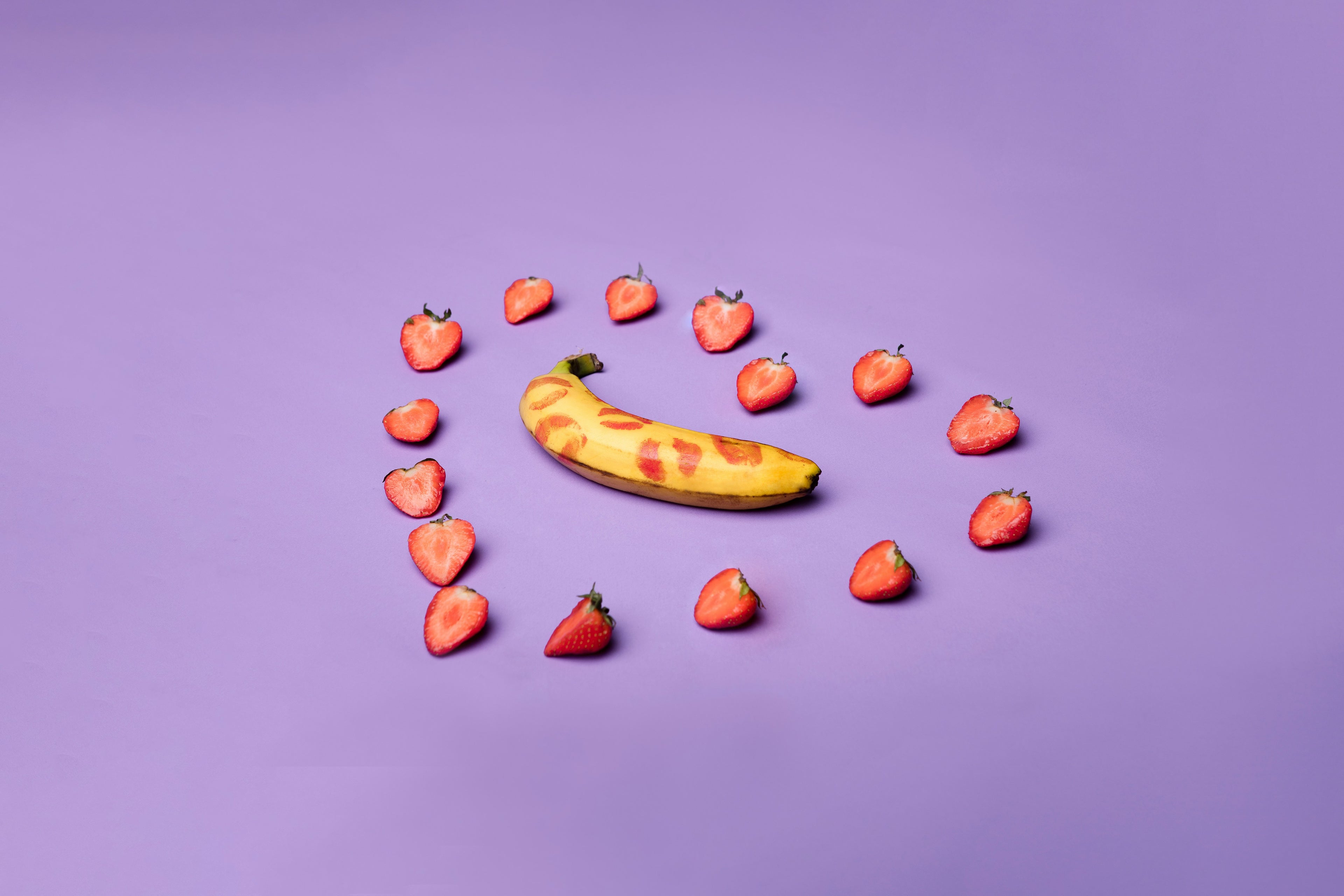 Strawberries arranged in a love shape with a kissed banana. Premium adult toys for women and men available online in the EU