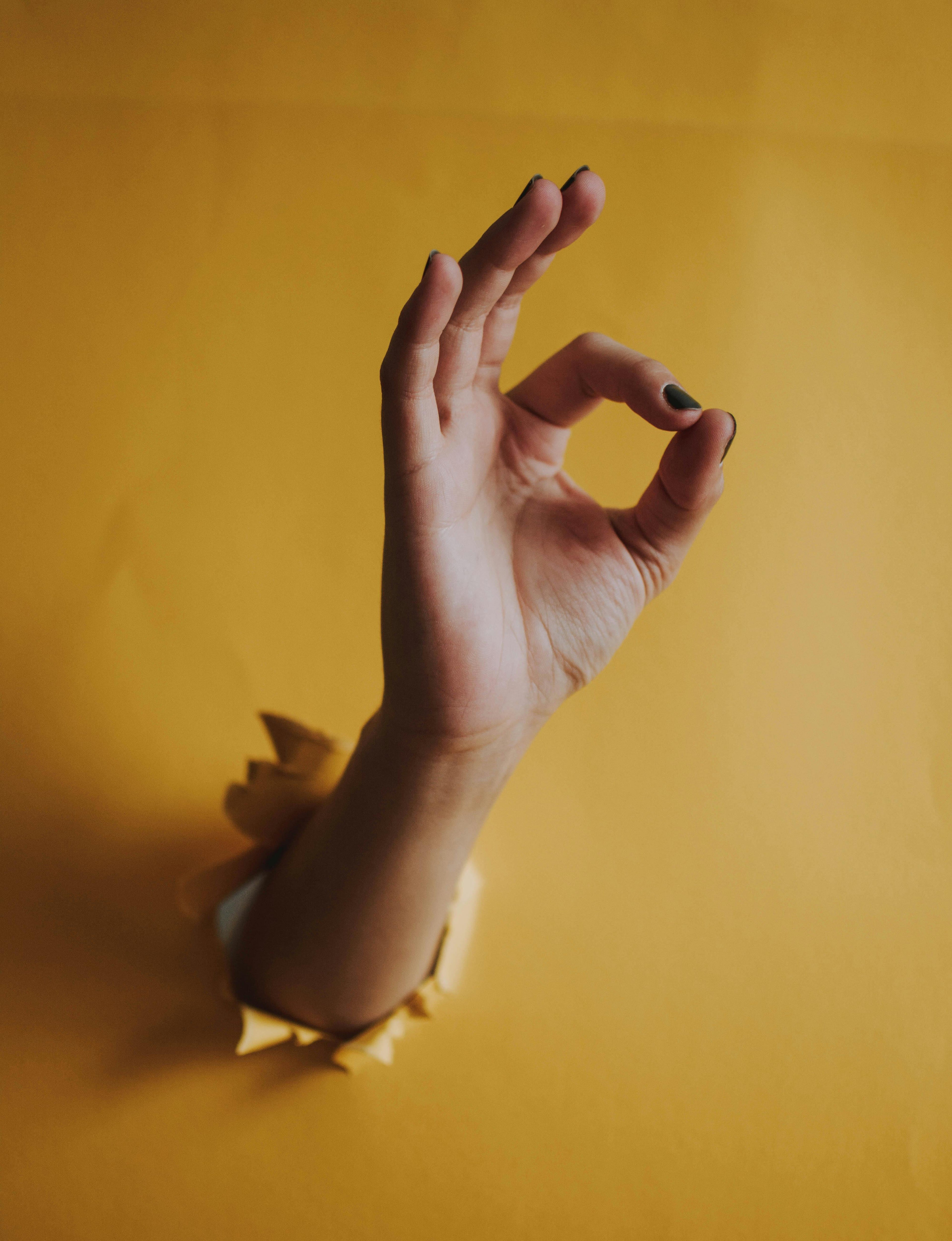 hand showing great cock ring product in yellow background, Premium cock rings designed to promote endurance, definition, and enhanced sexual performance for couples