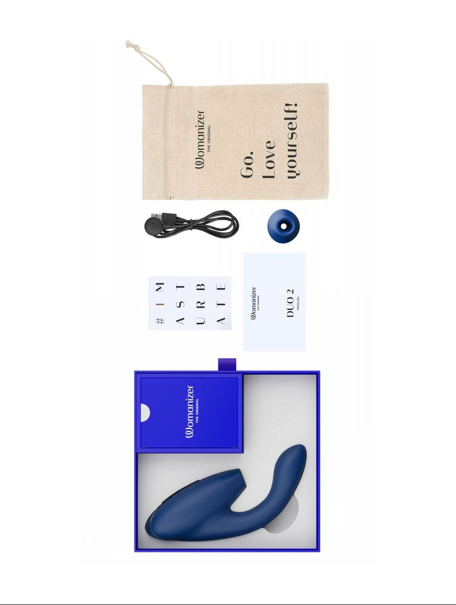 Womanizer erotic product set with packaging, manual, and accessories on a white background