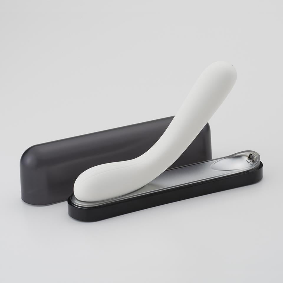 White and black curved sexual pleasure toy on a light gray background