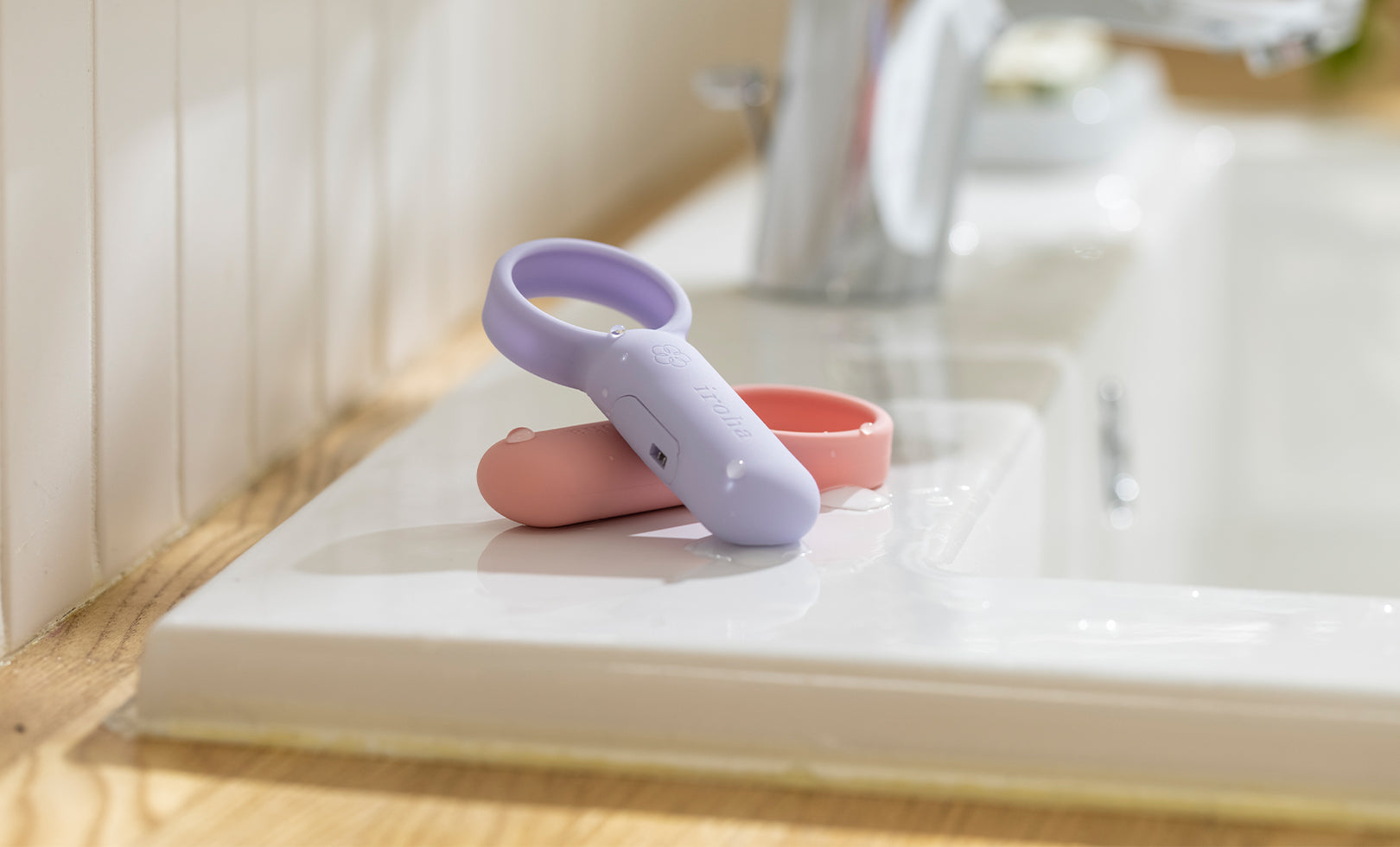 purple and pink dildos in a bathroom sink