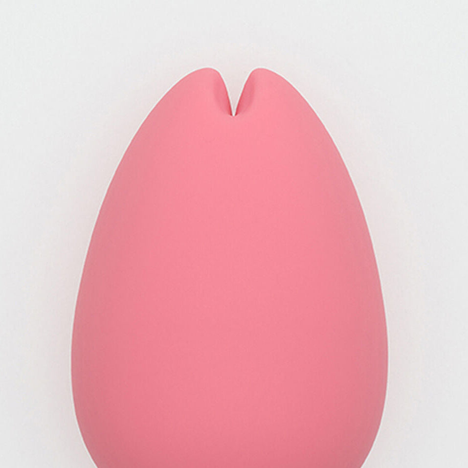 Pink silicone sexual wellness device with a split lip on a white background