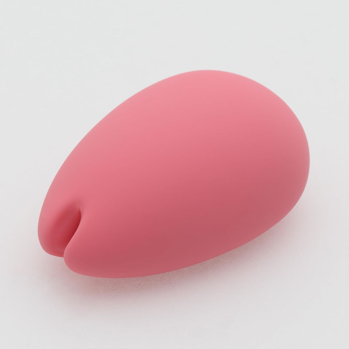 Pink silicone pleasure toy form on a white background