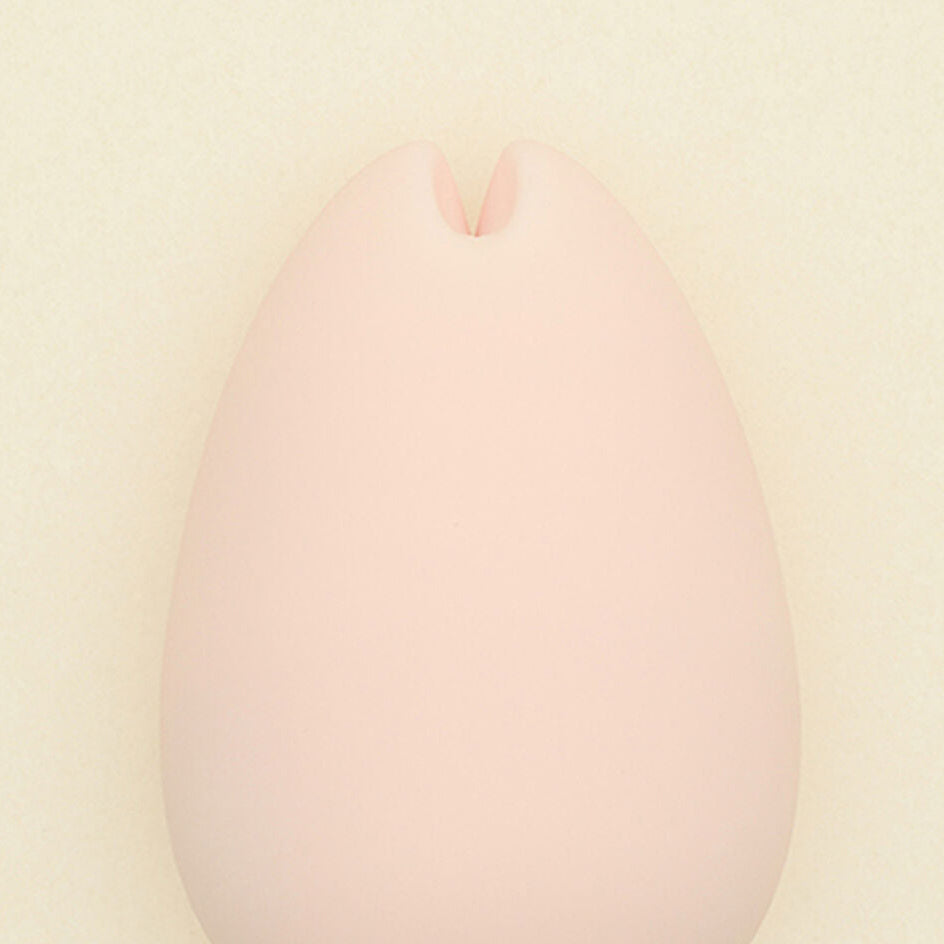 pink iroha sakura intimate massager on a beige background