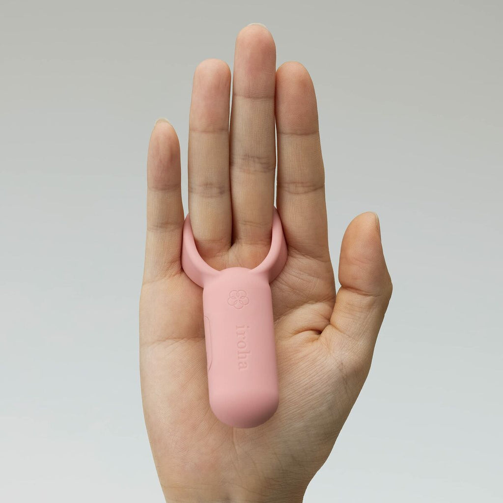 pink iroha finger vibrator held against a gray background 