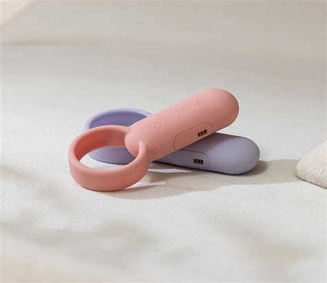 Pink and purple pleasure toys on a light beige surface