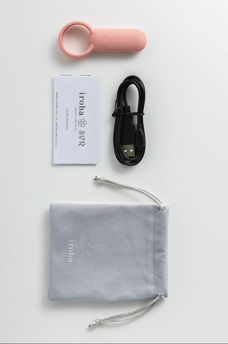 Pink iroha vibrating cock ring and finger vibrator, with recharging USB cable, and gray pouch with 'iroha' branding on a white background