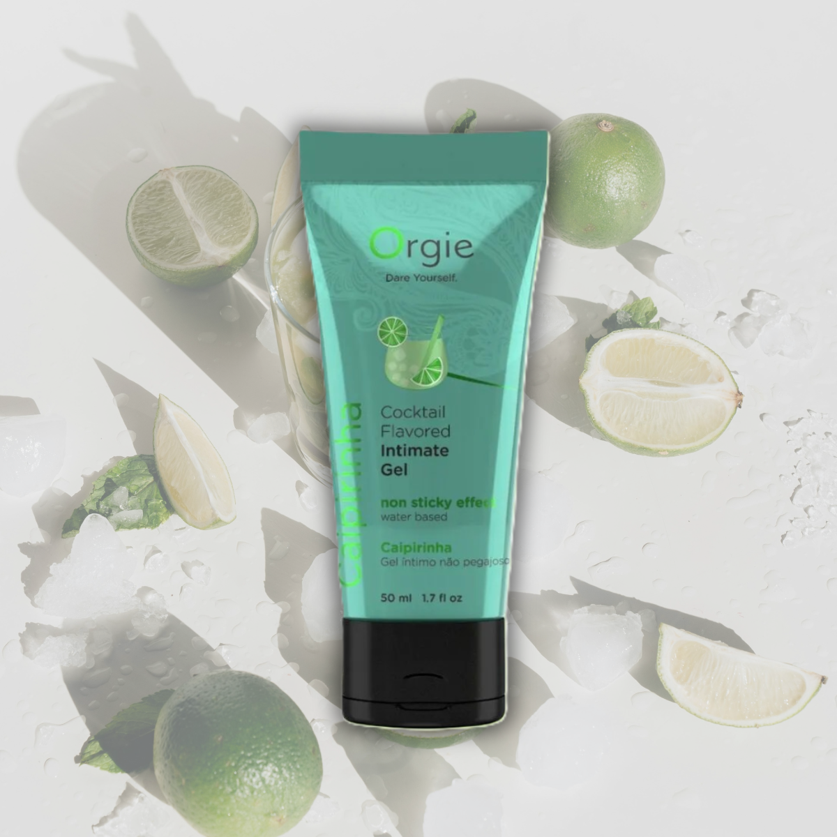 Tube of Orgie cocktail flavored intimate gel surrounded by lime slices on a light background