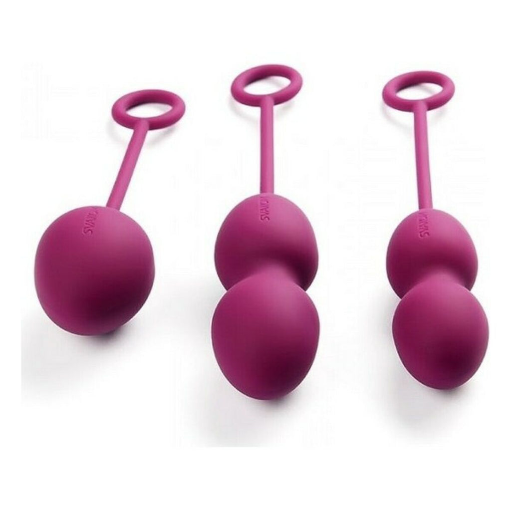 Set of three pink silicone chinese balls with handles on a white background