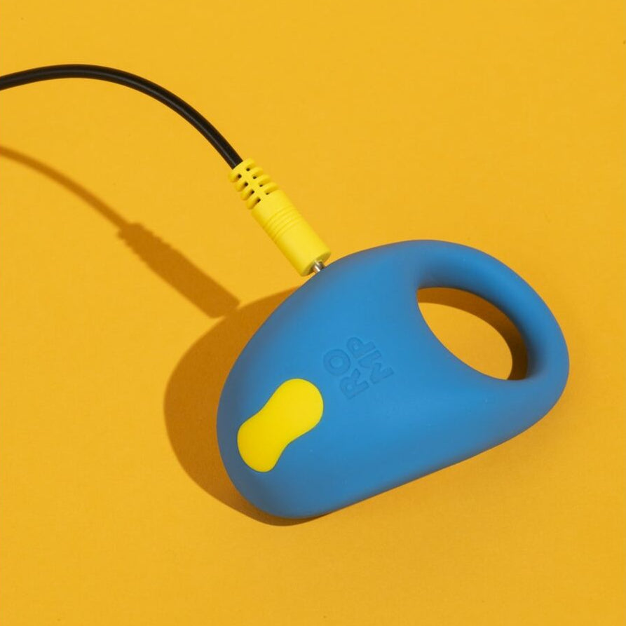 Blue and yellow rechargeable sexual wellness device with cable on a mustard yellow background