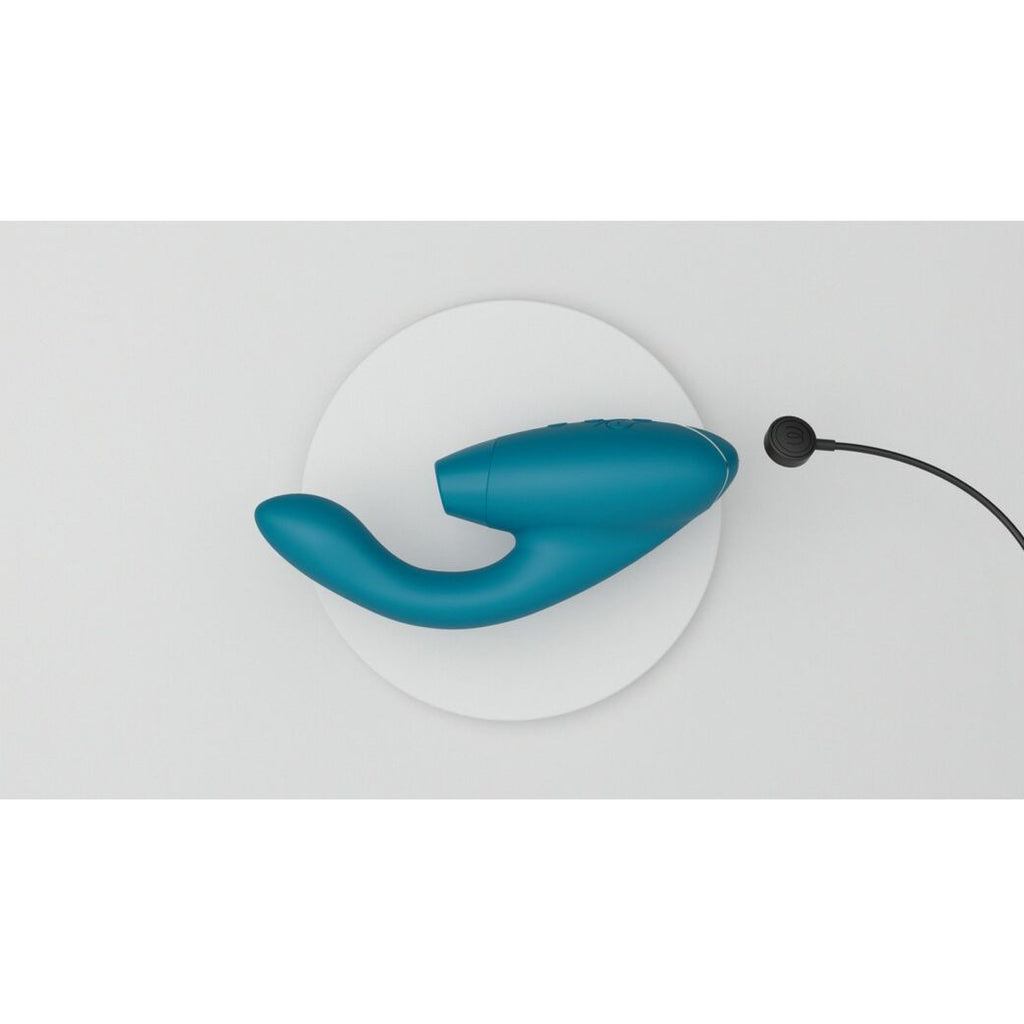 Blue intimate wellness device on a white background with charging magnetic cable