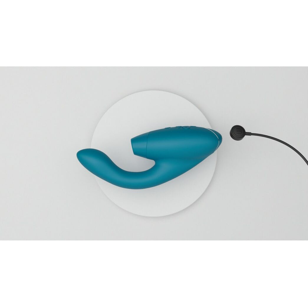 Blue intimate wellness device on a white background with charging magnetic cable