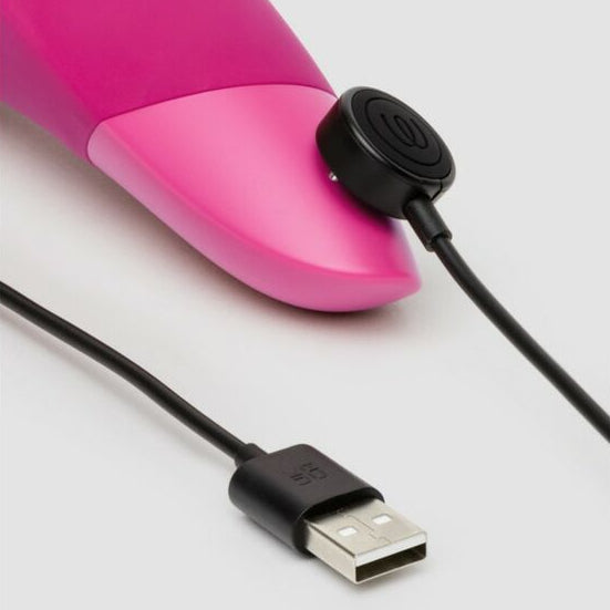 Pink adult erotic device with USB charging cable on a white background