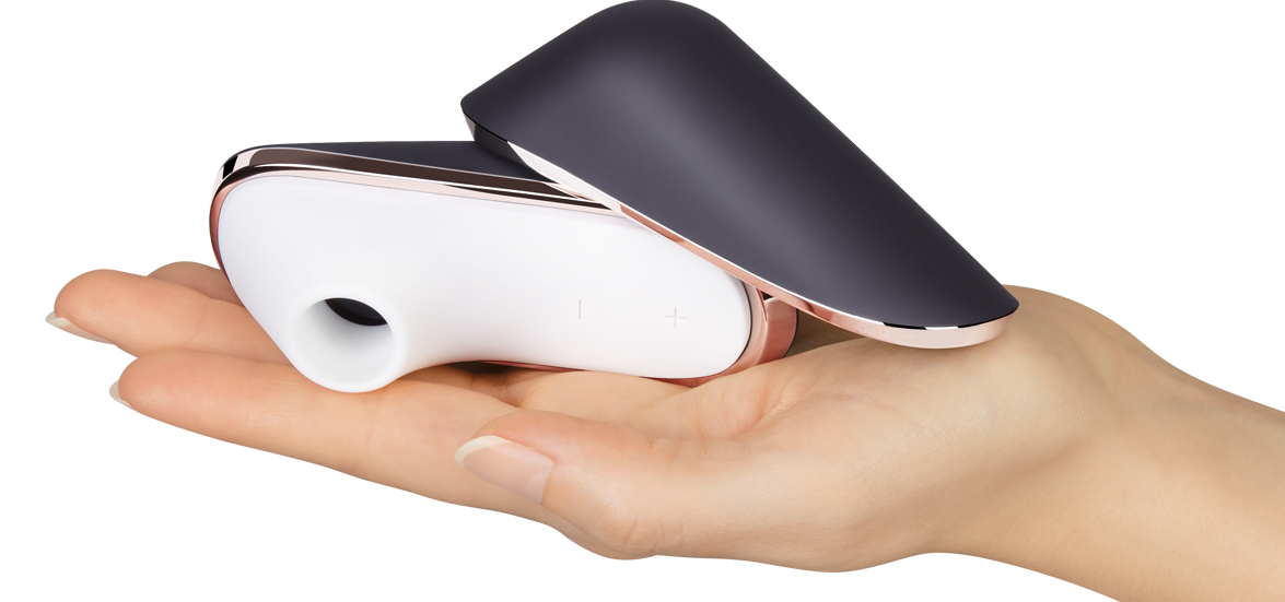 Hand holding a small clitoral stimulator device with a white and black design
