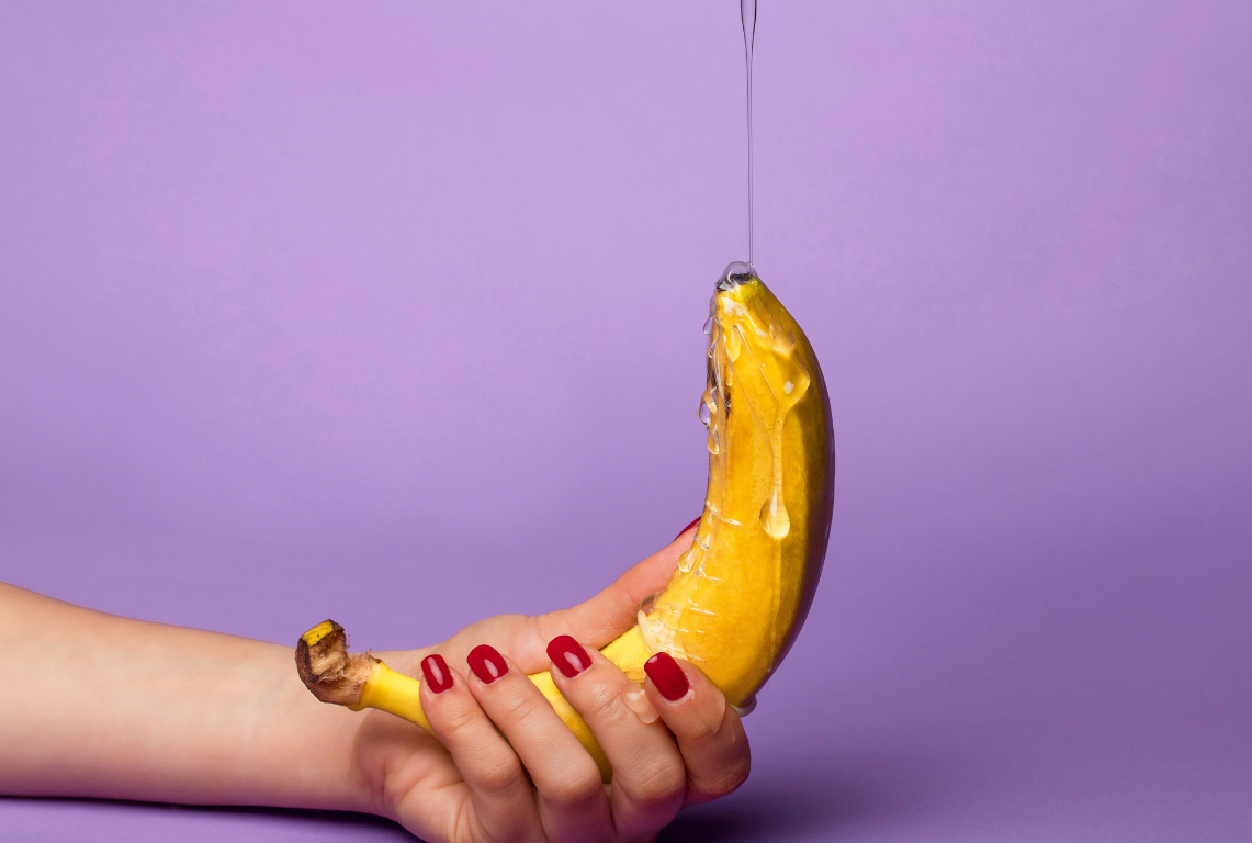 woman hand pouring handjob lube on banana