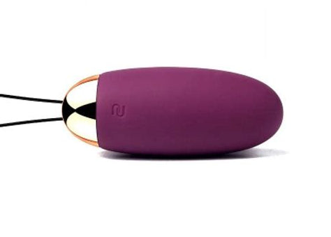 Purple silicone bullet vibrator device with a gold accent on a white background