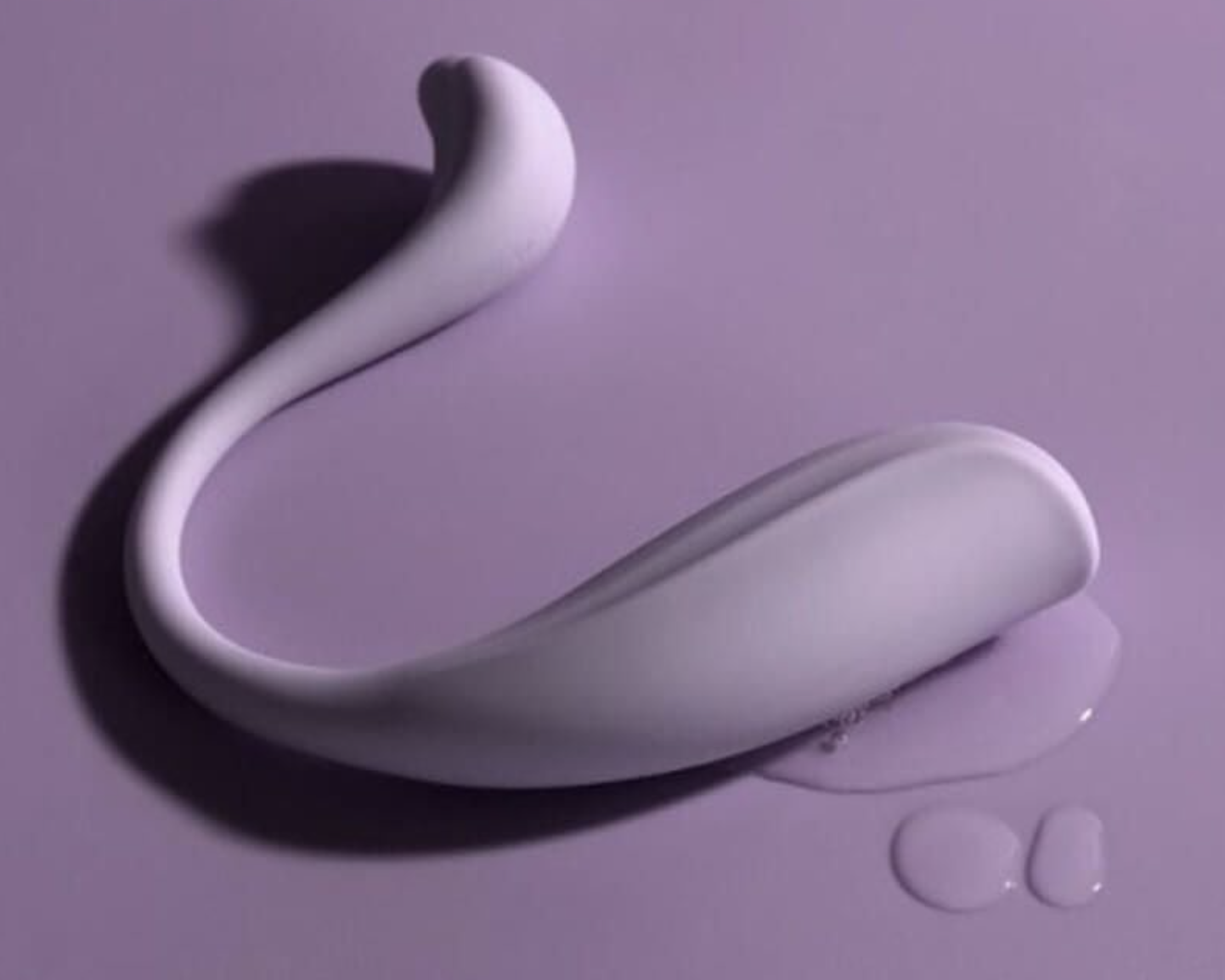 Purple curved intimate massager with lubricant on amatching purple background