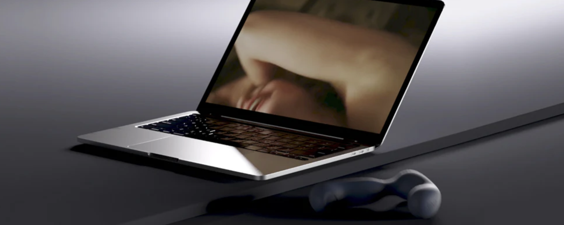 Laptop on a reflective surface with a blurred background