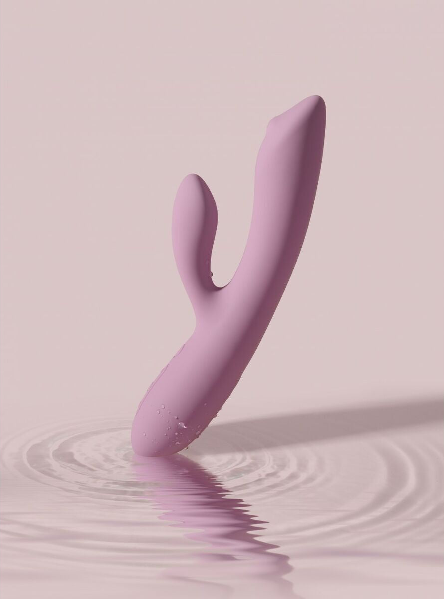 Pink silicone massager on a pink background