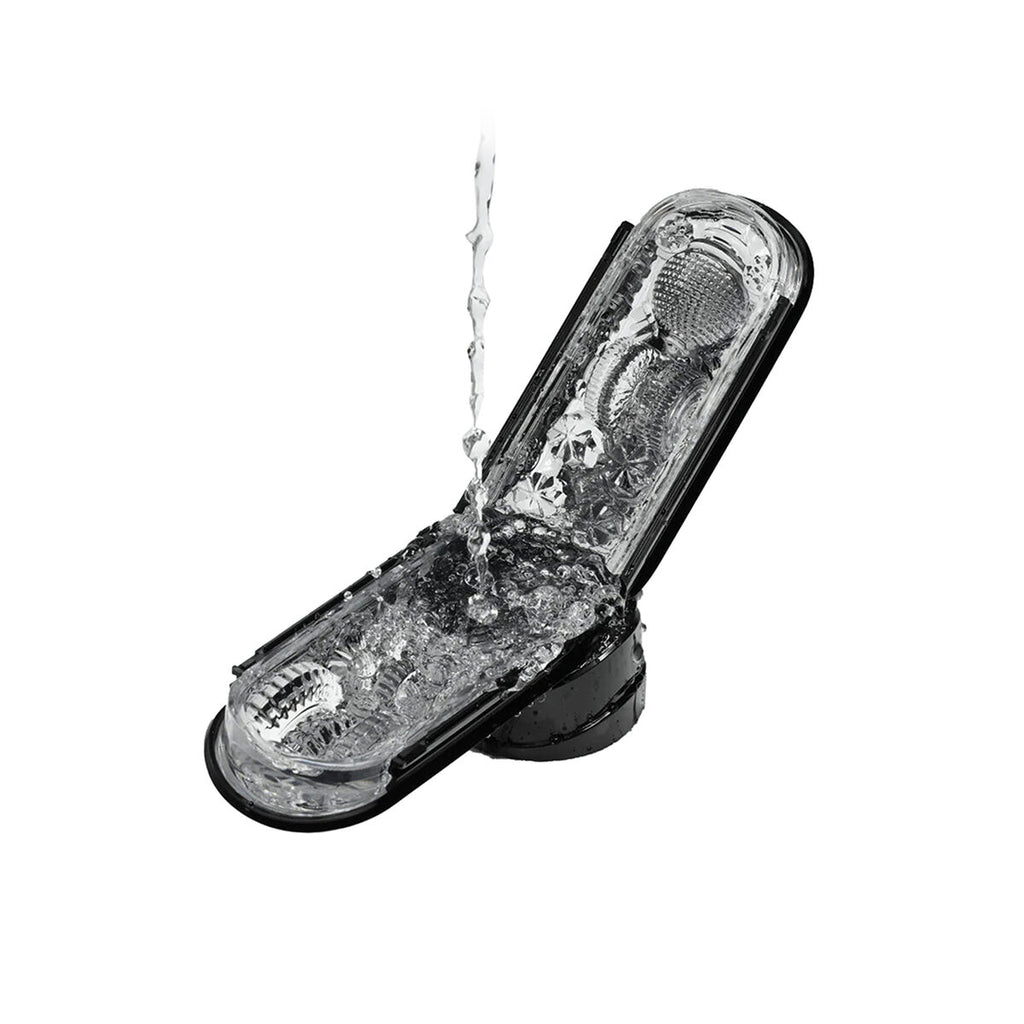 Clear plastic masturbator sleeve with lubricant flowing over it on a white background
