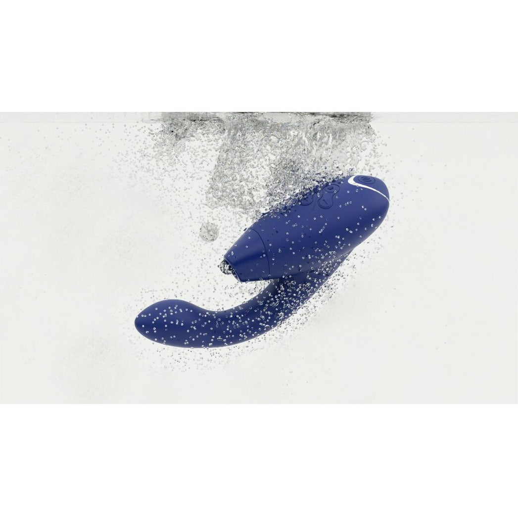 Blue vibrator emerging from water on a white background